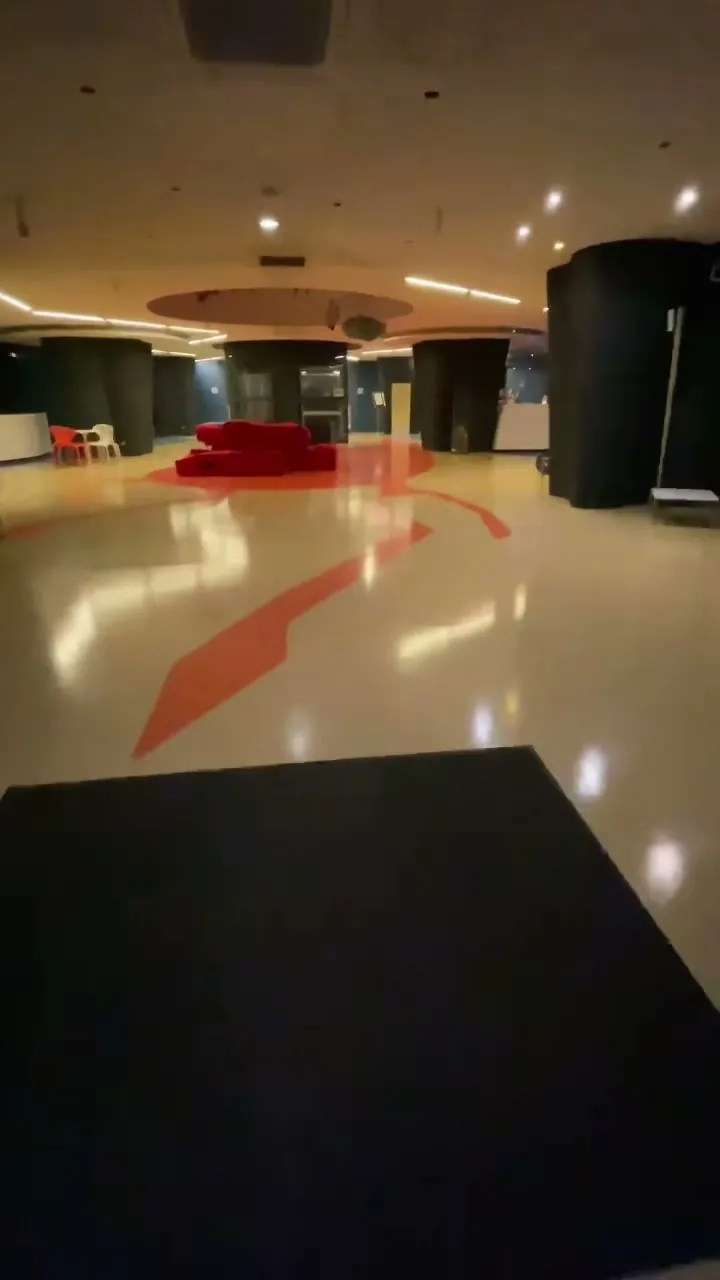 Empty hotel lobby with reflective floor and red accent